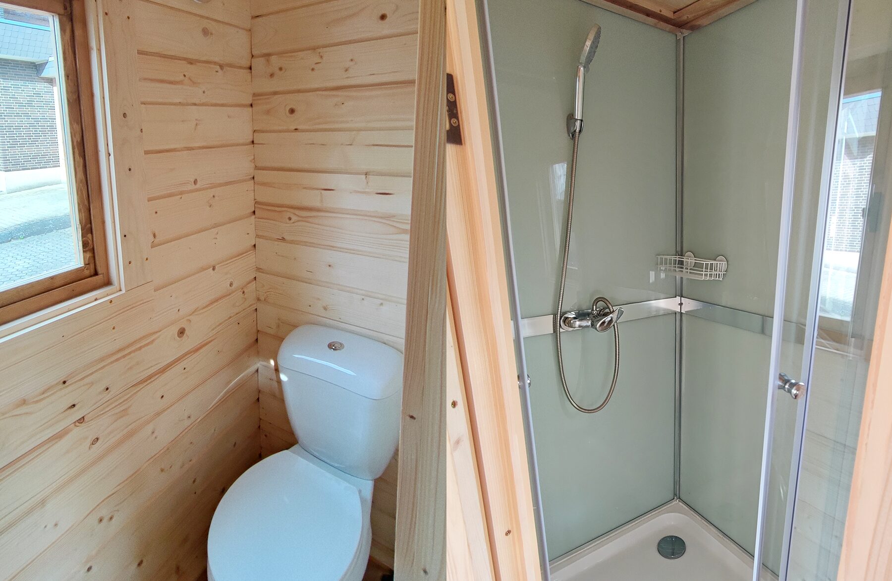 Interior view of a Feuerbad tiny house DELUXE bathroom: on the left, a compact toilet area with light wood paneling and a window providing natural light; on the right, a modern shower with glass walls, a handheld showerhead, and an integrated shelf, designed to be space-saving and functional.